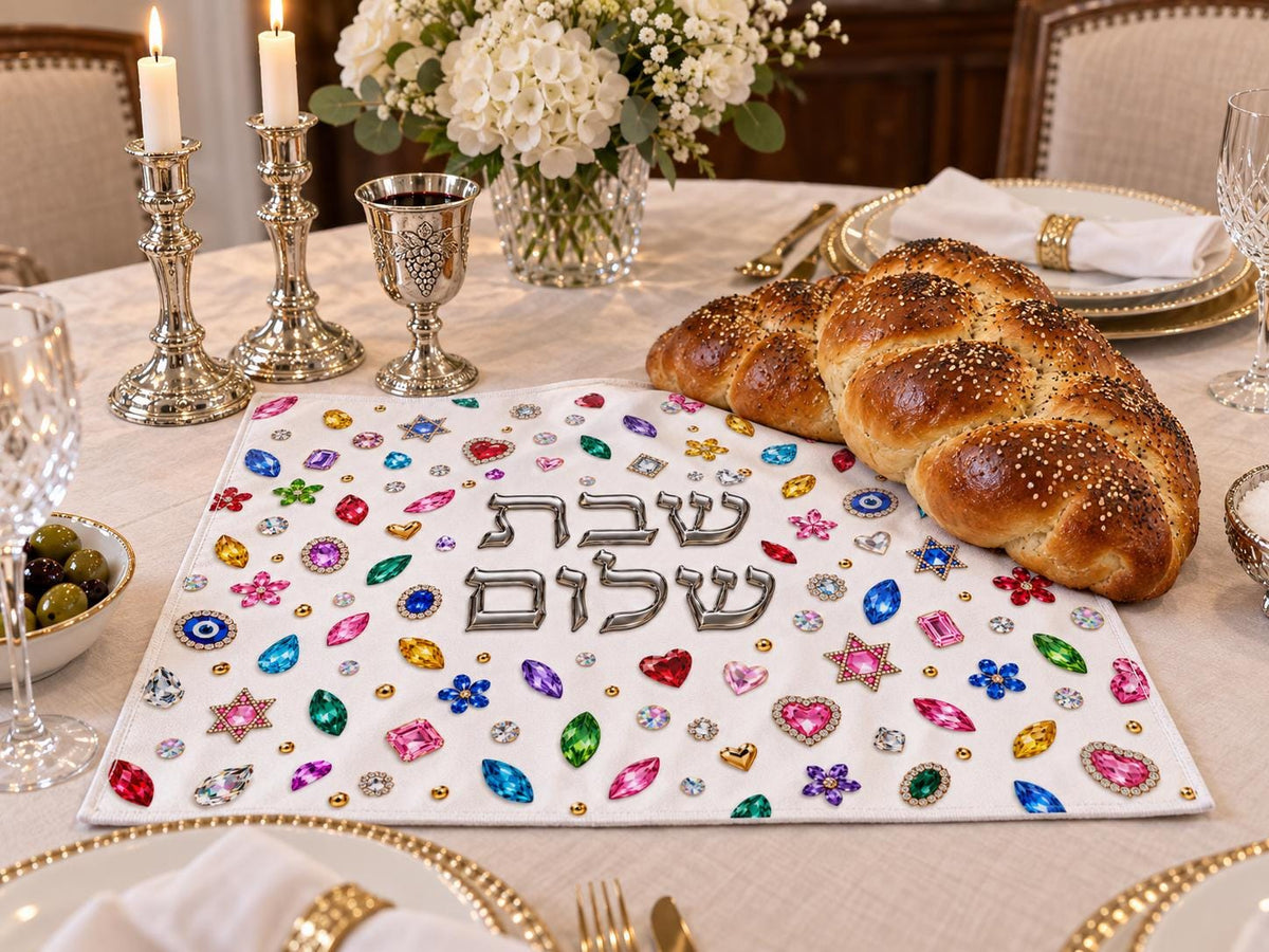 Challah cover on a set Shabbat table with candlesticks and challah